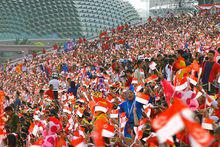 在新加坡國慶慶典上揮舞國旗的民眾