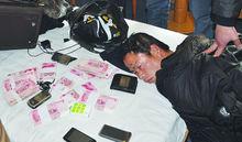 被擒獲的嫌犯唐某