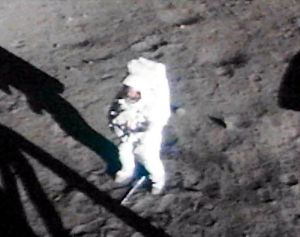 Armstrong on lunar surface with visor raised. From 16mm movie. (NASA)