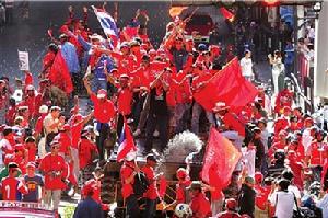 （圖）4月12日，在泰國首都曼谷，反政府示威者奪取一輛軍用裝甲車後在上面慶祝。