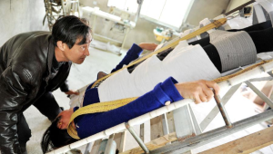 2015年4月12日，朱清華（左）演示他發明製作的“排石床”。 