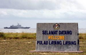 馬來西亞在中國彈丸礁上樹立的所謂“主權碑”，遠處為馬海軍巡邏艦