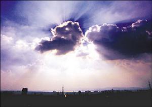 9日下午，霞光穿透雲層，遠遠看去像天空中的一朵“開心雲”