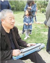 老人正在彈奏大正琴