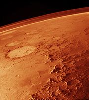 由低軌道所見，地平線上可見一薄薄的大氣二氧化碳是火星大氣主要成分。冬天時，極區進入永夜，低溫使大氣中多達25%的二氧化碳在極冠沉澱成乾冰，到了夏季則再度升華至大氣中。這個過程使得極區周圍的氣壓與大氣組成在一年之中變化很大。和太陽系其他星球相比，火星大氣有著較高比例的氬氣。不像二氧化碳會沉澱，氬氣的總含量是固定的，但也因為二氧化碳會在不同時間進出大氣，氬氣在不同地點的相對含量會隨時間而改變。近期衛星資料指出，南極區在秋季時氬氣含量提高，到了春季則會降低。火星大氣變化顯著。當夏季二氧化碳升華回大氣時，它留下微量的水汽。季節性、時速接近400公里的風吹離極區，帶著大量的沙塵與水汽，其中水汽造就了霜與大片捲雲。這些水冰雲由機會號於2004年攝得。2008年七月31日，NASA鳳凰任務的科學家證實地下凍的發現。鳳凰號的更多分析將確認這些冰是否曾為液態，或包含生命必需的有機物。鳳凰號的熱電傳導性探針（Thermal and Electrical Conductivity Probe）顯示當地大氣中的水分在火星晚上時會消失，同時土壤的水分則會增加。火星大氣中含量為十億分之一級（ppb）的微量甲烷，首次的發現來自2003年一支在NASA戈達德太空飛航中心的團隊。 2004年三月，火星快車號和自地面觀測的加法夏望遠鏡也支持甲烷的存在，濃度約10 ppbv。甲烷的存在十分吸引人，因為這是不穩定的氣體，要存在必有某種來源。據估計，火星每年必須產生約270公噸的甲烷，但由小行星帶來的只占0.8%。雖然地質活動也可提供，但火星近期缺乏火山活動，熱液活動、熱點等是甲烷來源的可能性就較低。