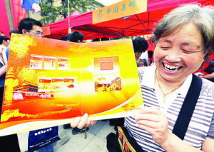 一位徐州老郵迷高興地展示《中國共產黨成立九十周年》紀念郵品。