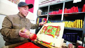 朱仙鎮木版年畫曹家老店第九代傳人曹新年師傅在印製式年畫中重要的紅色。