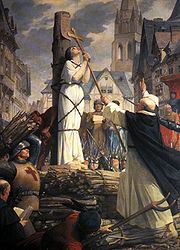 （圖）貞德被綁在火刑柱上，手握著十字架祈禱，為法國新古典主義畫家Jules-Eugène Lenepveu的作品