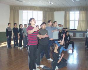 在農九師豫劇團排練大廳里演員正和邊防某團的戰士們一起排練文藝節目，慶祝邊防某團建團三十周年。