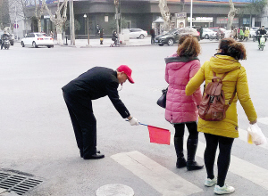 呂軍海向兩名欲闖紅燈的路人鞠躬