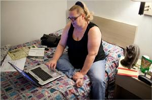 賈琳在汽車旅館上網找工，發申請。（紐約時報圖）